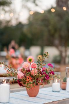 a table with candles and flowers on it