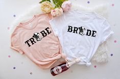 two t - shirts that say bride and groom sitting on a white furnishing