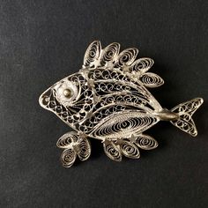 "This is a vintage pewter fish brooch with an intricate filigree design with small stars on head and fins of the fish.  The brooch has a needle on the back that is sturdy and well attached. The item is in a very good condition with all parts intact and just some slight natural patina on the metal. Size length: 6cm / 2 ⅜\" height: 5cm / 1 ⅞\" weight: 11 grams Worldwide shipping. For more vintage jewellery and home decor, please visit shop northvintageandart.etsy.com" Vintage Silver Fish-shaped Jewelry, Small Stars, Fish Brooch, Fish Jewelry, Bohemian Jewellery, Vintage Pewter, Brooch Vintage, Filigree Design, Silver Brooch