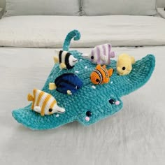 a crocheted stuffed animal is laying on a bed