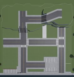 an aerial view of a street intersection in the middle of a green area with trees