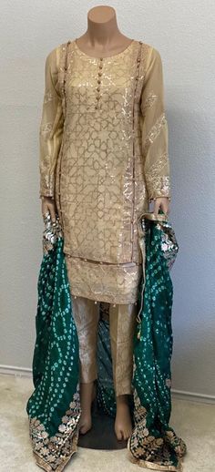 Pakistani Stitched Suit Salwar Kameez ReadyMadeSize: SmallMaterial:Shirt: Embroidered ChiffonTrouser: JamawarDupatta: Silk chunri with gota work Measurements:Chest 36 inchesWaist 32 inchesHips 40 inchesShirt length 38 inchesSleeves length 22 inchesTrouser length 37 inches!!!In STOCK Ready to ship within 1 business day via USPS priority mail!!!We highly recommend to check all the Images in the listing before making a purchase.To preview other items in our store please visit https://www.etsy.com/s Shantoon Lawn Suit With Dabka For Navratri, Traditional Gold Lawn Suit With Dabka, Eid Traditional Nida Wear With Mirror Work, Navratri Shantoon Lawn Suit With Dabka, Festive Kurta With Mirror Work In Fabric, Straight Kurta With Mirror Work In Shantoon, Gold Shantoon Lawn Suit For Weddings, Wedding Lawn Suit With Mirror Work For Navratri, Navratri Wedding Lawn Suit With Mirror Work