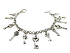 "Skeleton Keys Bracelet Show off your love of antique keys with this fun, unique piece of jewelry! Delicate bracelet, lovely to wear and wonderful to give. The charms and the bracelet are made from a zinc alloy metal which is both lead and nickel free. This is an awesome collection of charms for the realtor in your life! PLEASE NOTE: From time to time we may need to substitute one of the charms for another, all keeping with the theme of the collection. Charm is zinc alloy, lead and nickel free. Adjustable Key Bracelets As Gift, Metal Jewelry With Keys For Gifts, Vintage Metal Jewelry With Two Keys, Key Detail Metal Jewelry As A Gift, Vintage Metal Jewelry With Keys Detail, Vintage Metal Jewelry With Keys, Vintage Metal Key Jewelry, Bohemian Jewelry With Keys As Gift, Lover Bracelet