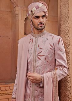 Step into the spotlight with the stunning Nude Pink Embroidered Sherwani Set, a creation that embodies grace and grandeur. Made from luxurious silk jacquard, the pink sherwani is adorned with intricate tonal velvet applique work and floral butta motifs, highlighted with zari and dabka embroidery, adding a touch of opulence. Paired with a matching kurta and pants, designed for a comfortable yet stylish fit, and completed with an embroidered stole, this ensemble ensures both a rich texture and a refined appearance. Ideal for the groom on his special day, this outfit combines traditional craftsmanship with contemporary design, offering a timeless appeal that exudes elegance. Composition : Sherwani, Stole, Kurta and Churidar - Silk JacquardCare: Dry Clean Only and Vacuum Storage Delivery : 4-6 Manpreet Toor, Pink Sherwani, Dabka Embroidery, Velvet Applique, Kaftan Kurta, Kurta Pants, Kurta Lehenga, Embroidered Sherwani, Prince Coat