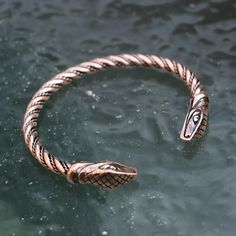 Please note that we only ship via FedEx (outside of the EU) and DPD (within the EU). The price is dependent on those carrier services' price lists. Snake - a bronze bracelet. Designed by Kati. Please note that FedEx does NOT deliver to PO boxes! Viking Style Metal Bracelet For Gift, Medieval Bronze Jewelry For Larp, Bronze Brass Jewelry For Larp, Medieval Gold Bracelet Jewelry, Medieval Style Gold Bracelet, Adjustable Antique Bronze Bangle, Bronze Antique Finish Bangle, Viking Style Metal Bracelet Jewelry, Handmade Viking Style Bronze Jewelry