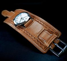 This leather cuff watch is made using fine, natural Italian, vegetable tanned leather which is hand stamped with a unique Native geo border. It's hand stitched using off-white thread and lined with smooth calf and closes with a stainless steel buckle. A new FM watch with a bright silver/white face tops it off. I'll need your wrist size. Please us the instructions in the pics above! - 2.25" (6cm) wide -Beautiful Natural Veg-tan leather - Classic FM style -Quality FM watch 316L stainless case, sapphire crystal, water resistant Thanks for checking out my work! I use a fine hand in my work bridging the gap between craft and art and truly LOVE making leather wristwear. ✻ Please leave all size information in the notes to seller at the end of checkout! You can also message it to me. In any event, Leather Watch Cuff, Vintage Hand Tools, Cuff Watch, Veg Tan Leather, White Face, Leather Cuffs, The Gap, Vegetable Tanned Leather, Watch Band