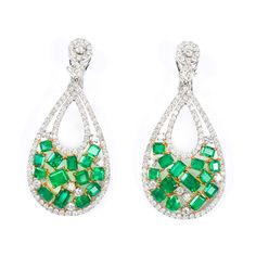 Magnificent Colombian emerald and diamond drop earrings in an 18K white and yellow gold setting. Featuring 7.2 carats of green emeralds (28 loose stones) with 5.44 carats of brilliant-cut diamonds (200 stones). Prong set 18K white and yellow gold 7.2 ct green emeralds 5.44 ct brilliant-cut diamonds MarkingHalmarks AKMS - 18K Measurements/WeightLength: 2 1/4 in. (5.7 cm)Width: 1 1/8 in. (3 cm)T.W.: 15 DWT (23.3 grams)WearExcellent condition. Luxury Green Diamond Earrings, Luxury Green Emerald Diamond Earrings, Green Diamond Earrings With 17 Jewels For Formal Events, Green Diamond Earrings With 17 Jewels For Formal Occasions, Luxury Green Diamond Earrings With Accents, Green Diamond Earrings In Fine Jewelry Style, Green Diamond Earrings Fine Jewelry, Green Diamond Earrings With Diamond Accents, Green Teardrop Diamond Earrings Fine Jewelry