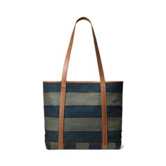 a blue and brown striped tote bag with leather handles on the front, side view