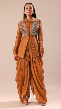 Experience the splendor of our copper brown kurta and palazzo set.
The jacket is detailed with cutdana and sequins.
This set is made from crepe tussar fabric.
This outfit is ideal for mehendi and sangeet events.
The kurta is coupled with a jacket and dhoti. Western Ideas, Kurta And Palazzo, Palazzo Set, Copper Brown, Simple Pakistani Dresses, Embroidered Jacket, Pakistani Dresses, Chic Outfits, Embroidery Designs