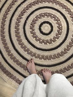 a person standing in front of a rug on the floor