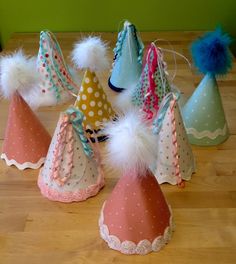 small party hats with pom poms on them