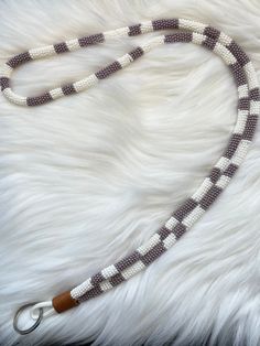 This lanyard is handmade with pearl purple 11/0 seed beads, and white 11/0 seed beads, white paracord, tan leather and silver keychain ring. Adjustable White Beaded Lariat Necklace, White Adjustable Lariat Beaded Necklace, Handmade White Necklace For Everyday Use, Handmade White Necklace For Everyday, Handmade White Jewelry For Everyday Use, White Round Beads Necklace For Everyday Use, White Beaded Everyday Jewelry, White Round Beaded Necklaces For Everyday, White Beaded Jewelry For Everyday Use