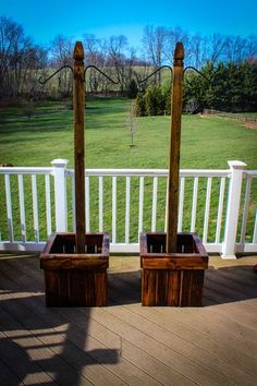 two wooden planters sitting on top of a deck