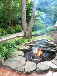 a fire pit in the middle of a garden