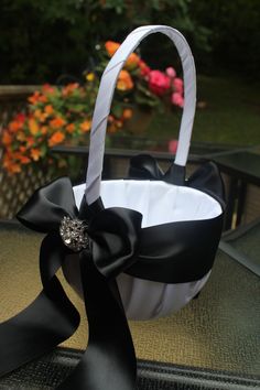 a black and white basket with a bow on it