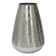 a metal vase with intricate designs on it's sides and bottom, sitting against a white background