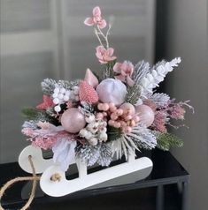 a sled filled with lots of pink and white flowers