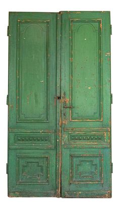 an old green wooden door with metal handles