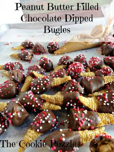 peanut butter filled chocolate dipped buggies on a plate with sprinkles and candy