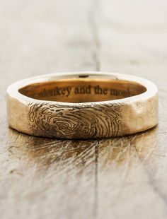 a wedding ring with the words monkey and the man engraved on it's side