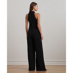 With a nod to traditional tuxedo designs this jumpsuit features a vest-inspired bodice with a satin shawl collar and a wide-leg silhouette accented by satin side-stripes and creases along each leg. A refined choice for a special occasion this style is crafted with double-faced crepe for a smooth hand feel. Chic Semi-formal Tuxedo, Chic Semi-formal Pantsuit With Structured Boning, Chic Formal Satin Jumpsuits And Rompers, Evening Pantsuit With Structured Boning, Elegant Sleeveless Fitted Tuxedo, Fitted Pantsuit With Structured Boning, Evening Suits With Structured Boning, Formal Fitted Full-length Jumpsuit/romper, Chic Sleeveless Satin Jumpsuit