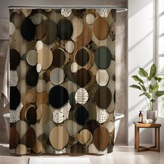 a bathroom with a shower curtain that has circles and dots on it, along with a potted plant in the corner