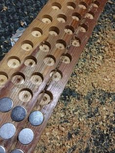 a close up of a wooden board with metal circles on the top and bottom part