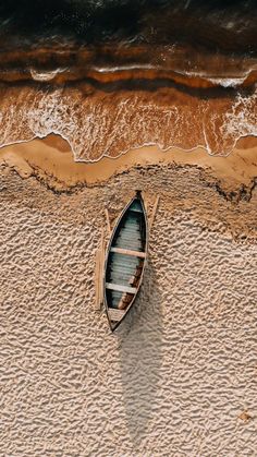 an aerial view of a boat on the beach