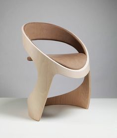 a wooden chair sitting on top of a white table