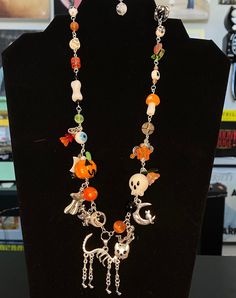 pumpkin and skeleton themed necklace! handmade, one of a kind :) Handmade Adjustable Jewelry For Halloween, Handmade Bohemian Jewelry For Halloween, Handmade Themed Pendant Jewelry, Unique Halloween Pendant Necklaces, Halloween Gift Necklace With Lobster Clasp, Unique Halloween Gift Necklaces, Handmade Spooky Dangle Jewelry, Handmade Dangle Halloween Jewelry, Handmade Halloween Pendant Necklace