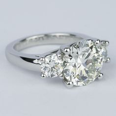 Three Stone Platinum Diamond Ring, Luxury Three Stone Formal Jewelry, Luxury Formal Three Stone Jewelry, Three Stone Cushion Cut Platinum Diamond Ring, Luxury Three Stone Jewelry For Formal Occasions, Platinum Cushion Cut Three Stone Diamond Ring, Formal Gia Certified Rings, Formal Gia Certified Round Stone Ring, Platinum Three Stone Cushion Cut Ring