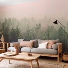 a living room with a couch, coffee table and wall mural on the wall behind it