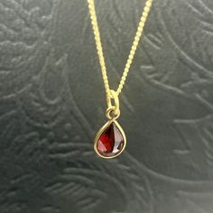 A red Garnet drop pendant with a brass necklace sounds like a beautiful piece of jewelry. Garnet is a deep red gemstone known for its rich color and symbolism of love and passion. The brass necklace adds a touch of elegance and complements the red Garnet pendant nicely. It would make a great addition to any jewelry collection or a thoughtful gift for someone special. Red Drop Beads For Jewelry Making, Red Gemstone Drop Necklace For Gift, Gold Gemstone Drop Necklace For Gift, Red Drop Necklace For Gift, Elegant Red Drop Necklace For Gift, Red Gemstone Drop Jewelry, Red Drop Gemstone Jewelry, Red Teardrop Gemstone Drop Necklace, Gift Garnet Drop Jewelry