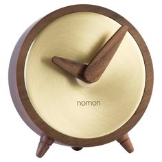 an alarm clock with the word nomon on it's face and wooden hands