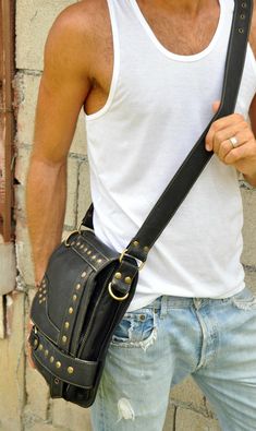 "Guys, you need this stylish shoulder bag for essentials, like your notebook or mini laptop devices, your phone, journal, wallet and keys. And, ladies, you already know how beneficial crossbody handbags are and this one is hard-core, smokin' biker bad. Oversized brass nailhead studs and an edgy geometric design make this an artistic statement that'll enhance even a basic, solid color t-shirt. Functional and secure, this hip bag features 2 exterior zipper compartments, 1 interior zipper compartme Everyday Carry Crossbody Shoulder Bag, Portable Crossbody Satchel For Everyday Use, Casual Portable Shoulder Bag For Everyday Carry, Portable Shoulder Bag For Everyday Carry, Daily Use Shoulder Satchel, Portable Rectangular Bag For Everyday Carry, Casual Everyday Carry Rectangular Bag, Casual Rectangular Everyday Carry Bags, Portable Leather Satchel For Everyday Use