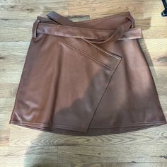 Divine Heritage Faux Leather Wrap Asymmetrical Belted Mini Skirt In Saddle Brown Size Large Never Worn Brown Belted Fitted Mini Skirt, Fitted Brown Belted Mini Skirt, Brown Fitted Belted Mini Skirt, Chic Brown Leather Mini Skirt, Belted Brown Skirt, Chic Asymmetrical Mini Skirt With Belt Loops, Chic Leather Skirt With Belt Loops, Chic Irregular Bottoms For Fall, Chic Irregular Fall Bottoms