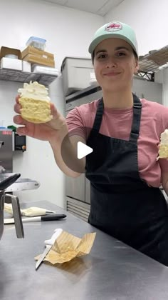 a woman holding up some food in her hands