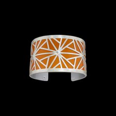 Silver Bracelet - Designer and artist Gogo Borgerding specializes in crafting statement cuffs featuring bold geometric patterns and striking colors. All sterling silver is etched, pierced, sawed, forged and riveted for a cold connection with an anodized aluminum backing to give a distinctive pop of color.<br>This graceful, eye-catching cuff pleases with soothing a orange hue, and is made to easily roll on and off for a comfortable, loose fit; for a tighter fit, squeeze sides gently. Aluminum Bracelets, Stainless Steel Welding, Silver Cleaner, Soft Toothbrush, Jewelry Studio, Anodized Aluminum, Silver Pieces, Artistic Jewelry, Roll On