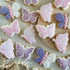 cookies decorated with pink and blue butterflies on a table