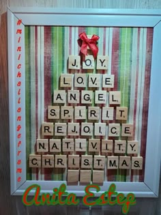 a scrabble christmas tree made out of wood blocks with the words joy, love, angel, spirit, rejoice, nativity and christmas