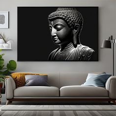 a black and white photo of a buddha statue on a wall above a couch in a living room