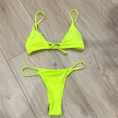 Neon Yellow String Bikini. Adjustable Straps. Comes With Removable Pads In Bikini Top. Never Worn Yellow Strappy Swimwear For Poolside, Yellow Strappy Swimwear For Beach, Yellow Strappy Swimwear For Vacation, Yellow Strappy Swimwear For The Beach, Yellow Strappy Swimwear For Summer, Yellow Strappy Summer Swimwear, Neon Yellow Party Swimwear For Summer, Yellow Strappy Swimwear, Yellow Fitted Strappy Swimwear