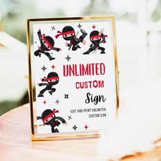 a sign with ninjas on it sitting on top of a wooden table in front of a window