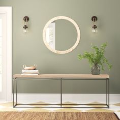 a room with a table, mirror and potted plant