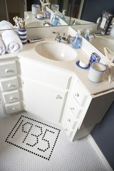 a bathroom with a sink, mirror and toiletries on the counter in front of it