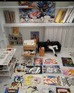 a room filled with lots of different types of artwork on the walls and flooring