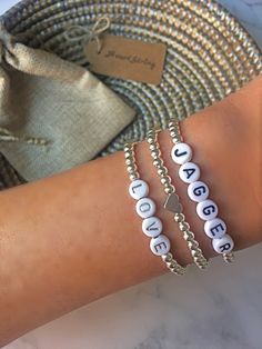 "Our Sterling Silver Personalized Bracelets are elegant, timeless + infinitely meaningful. Carefully handcrafted per order, each bracelet fits perfectly + is truly one-of-a-kind. 💫 Create bracelets with names, words, initials, affirmations, mantras, etc; the possibilities are limitless. Wear one as a statement piece or create a unique stack. Stylish and versatile, these are great for everyday wear, as well as special occasions. 💫 💝 These also make incredibly thoughtful gifts! [We offer custom Bracelets With Names, Silver Beaded Bracelets, Word Bracelets, Burlap Gift Bags, West New York, Sterling Silver Bead Bracelet, Word Bracelet, Letter Bracelet, Women's Bracelets