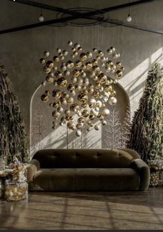 a living room filled with lots of furniture and christmas ornaments hanging from the ceiling above