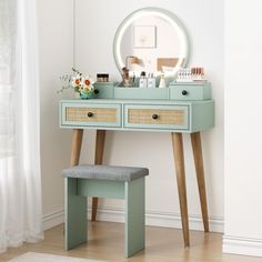 a blue vanity with drawers and a stool