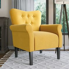 a yellow chair sitting on top of a white rug